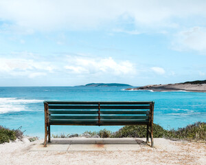 Naklejka na ściany i meble Sit at the bench and watch the beauty summer-day beach. 