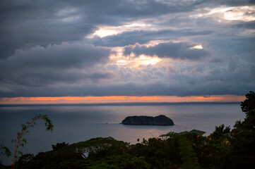 Sunset over the Pacific Ocean on a cloudy evening in Costa Rica.