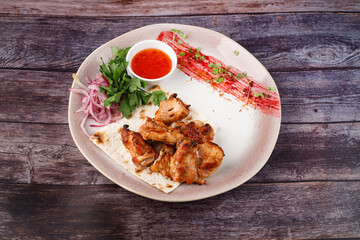 Grilled meat and vegetables on a white plate