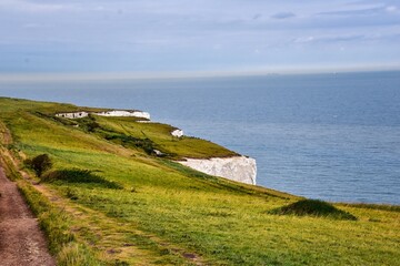 Fototapeta na wymiar White Cliffs of Dover. Close up detailed landscape view of the cliffs from the walking path by the sea side. September 14, 2021 in England, United Kingdom, UK.