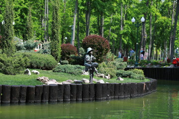 a beautiful large park with well-groomed animals and a river in the city