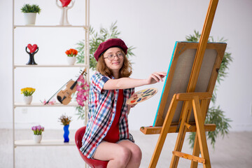 Young girl enjoying painting at home