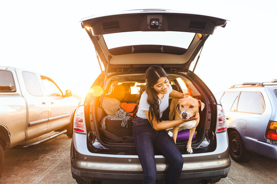 Woman With Dog Sitting In Car