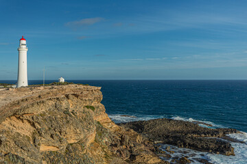 Fototapeta na wymiar Cape Nelson Lighthouse and coastline on the southern ocean in Victoria, Australia