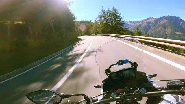 A highway motorcycle ride on a sunny summer day, at the Simplon Pass in Switzerland.