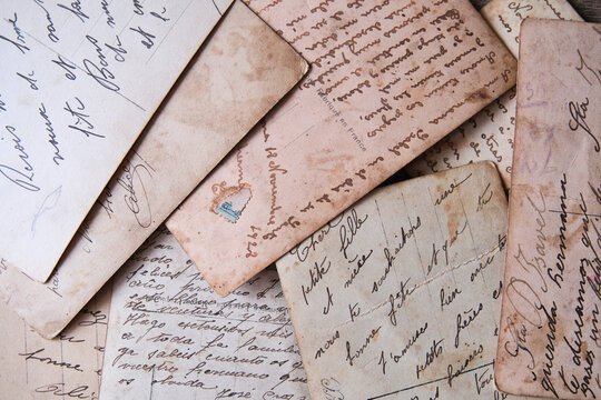 pile of old handwritten letters scattered on the table