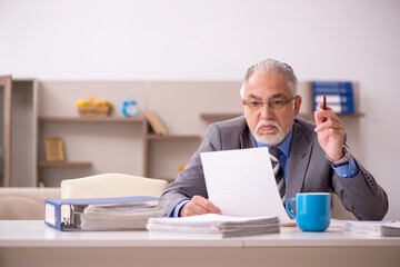 Fototapeta premium Old male employee working from home during pandemic