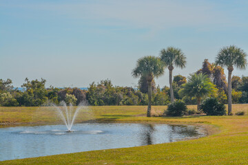 A fountain, a pond and palm trees on Jekyll Island, Glynn County, Georgia