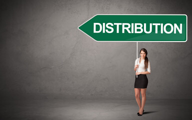 Young business person in casual holding road sign