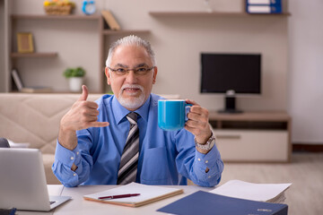 Old male employee working from home during pandemic