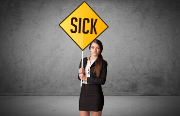 Young business person holding road sign