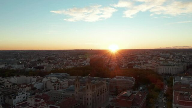 Forwards fly above town in sunset time. Revealing San Jeronimo el Real church and National Museo del Prado.
