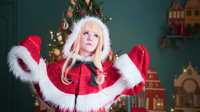 Girl cosplaying Christmas Miku Santa dress with gifts. New Year's elf. Posing for the photographer