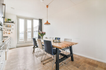 Decorative chairs and wooden table in dining room