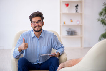 Old man visiting young male psychotherapist