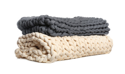 Chunky knit blankets folded on white background