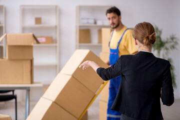 Young female boss and male contractor doing home relocation
