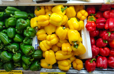 Malaysia, Perak, 10 December 2021: Red, yellow and green capsicum located and sold in a supermarket