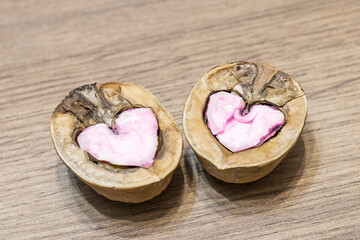 Two halves of walnuts, hearts, love symbol, place for text