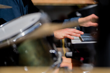 close up of musician playing keyboard and piano, in a band, at a music gig, in Australia.