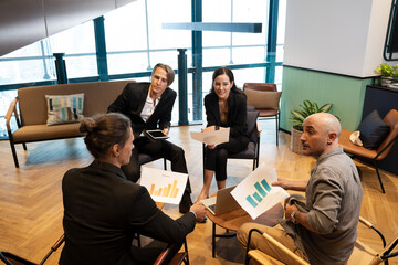 Business People having meeting in office,Successful business team of four sitting in office and planning work.