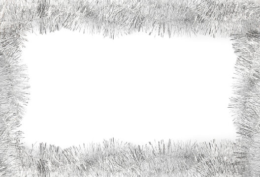 Frame made of shiny silver tinsels on white background, top view. Space for text