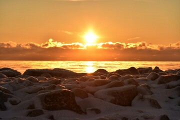 Snowy rocks sunrise over lake