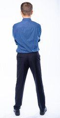 man stands with his back in the studio on a white background in trousers and a shirt
