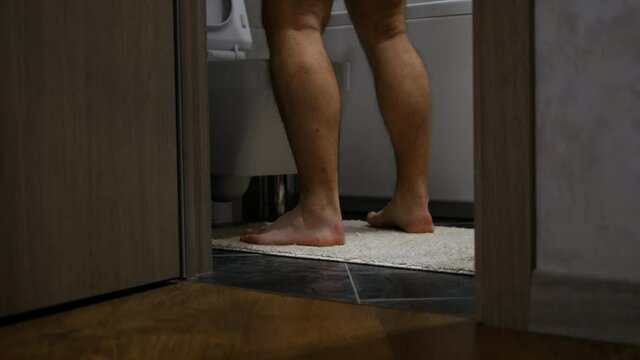 A man runs in the toilet, prostate adenoma, a man urinates in the toilet. Problems of the male genitourinary system