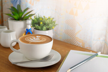 Cappuccino coffee in a beautiful glass on the table favorite cup of coffee concept.