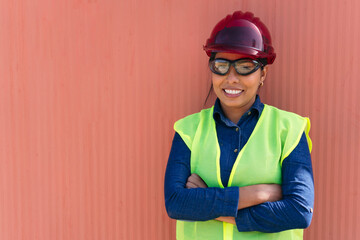 Portrait of a female worker in a factory with hard hat