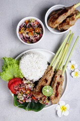Sate Lilit, traditional Balinese minced seafood or chicken satay with lemongrass as aromatic skewer, served with sambal matah.