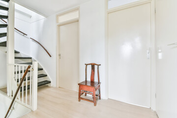 Stylish spiral staircase with black carpet floor and comfortable wooden handrails