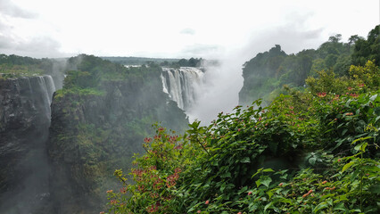 Victoria Falls streams are collapsing from the edge of the plateau. There is a thick fog over the...