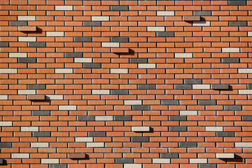 The street wall of multicolor bricks. Beautiful bricks background with protruding ones