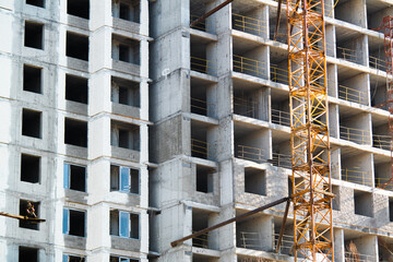 Unfinished building construction in the city tall crane