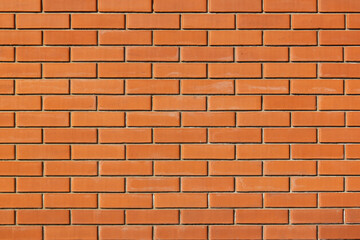 The street wall of orange bricks. Beautiful bricks background with protruding ones