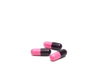 photograph of capsule pills on a white background