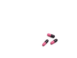 photograph of capsule pills on a white background