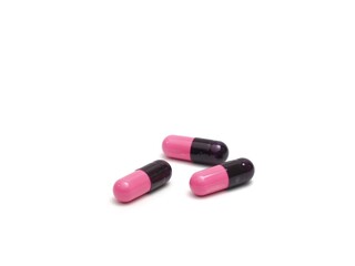 photograph of capsule pills on a white background
