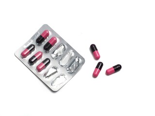 photograph of capsule pills on a white background