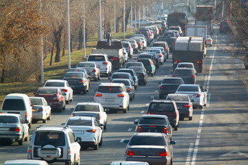 Road traffic congestion. Many different cars are stuck in a traffic jam in a city street. Diagonal view