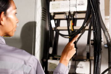 Asian 20s woman in grey uniform as electric fix repair guy. Engineer check inspect wifi signal