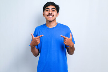 Man wearing casual shirt looking confident with smile on face, pointing oneself with fingers proud and happy