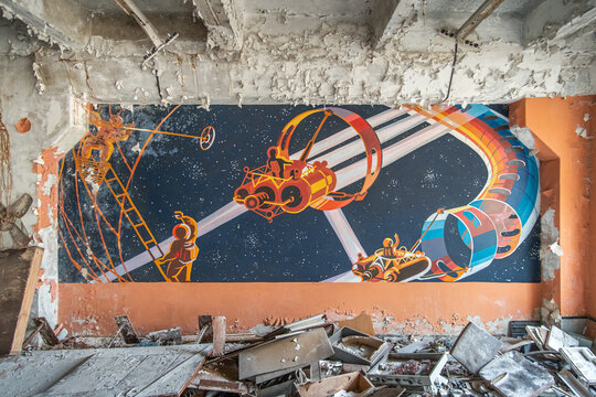 Soviet drawing with space on the theme of science fiction in an abandoned ruined building. Chernobyl, Ukraine - November 2021.