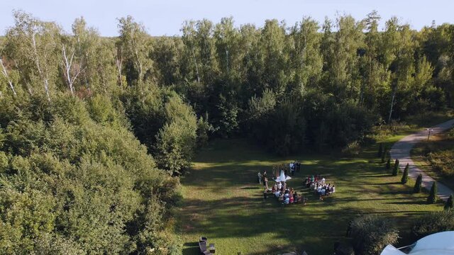 Russia, Nizhny Novgorod region, Kstovsky district, Kadnitsa village, August 14, 2021. Aerial photography from a quadrocopter - wedding ceremony in nature, on-site registration of the wedding