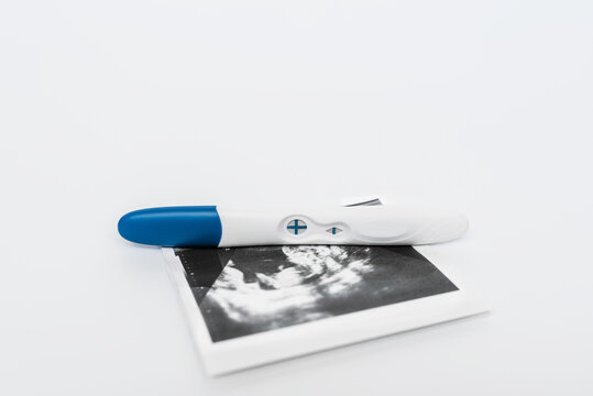 Positive pregnancy test on ultrasound photo. A positive pregnancy test result. Pregnancy test showing a positive result. Ultrasound photos of the child. Copy space