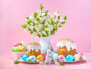 Easter composition on a pink background. Cherry flowers, cupcakes and Easter eggs. Spring concept