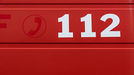 112 phone number on a red background 