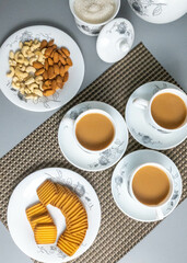 Tea time with Biscuits and dry fruits, White Plan Cashew, and Almonds.
seave in the white marble Tea set. 